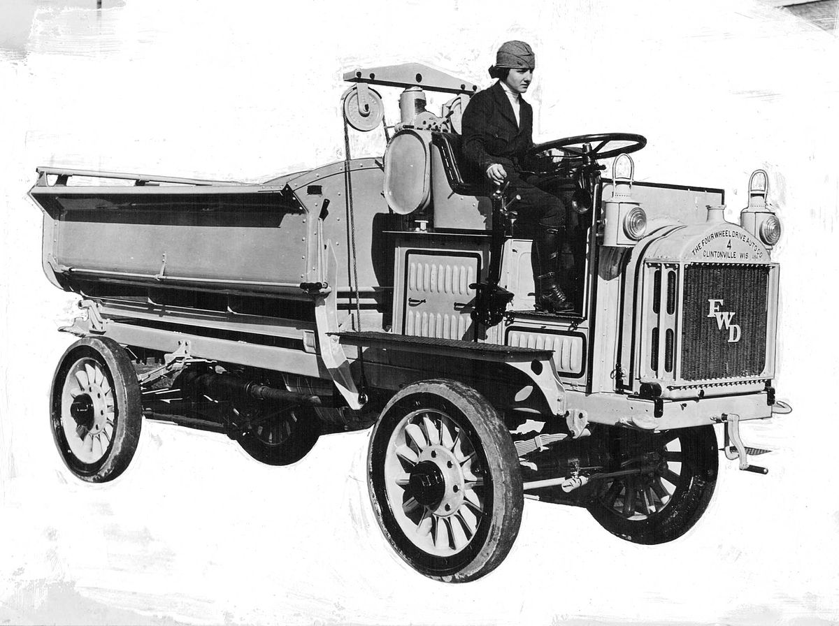 1200px-Luella_Bates_driving_a_Model_B,_FWD_truck,_promotional_photo.jpg