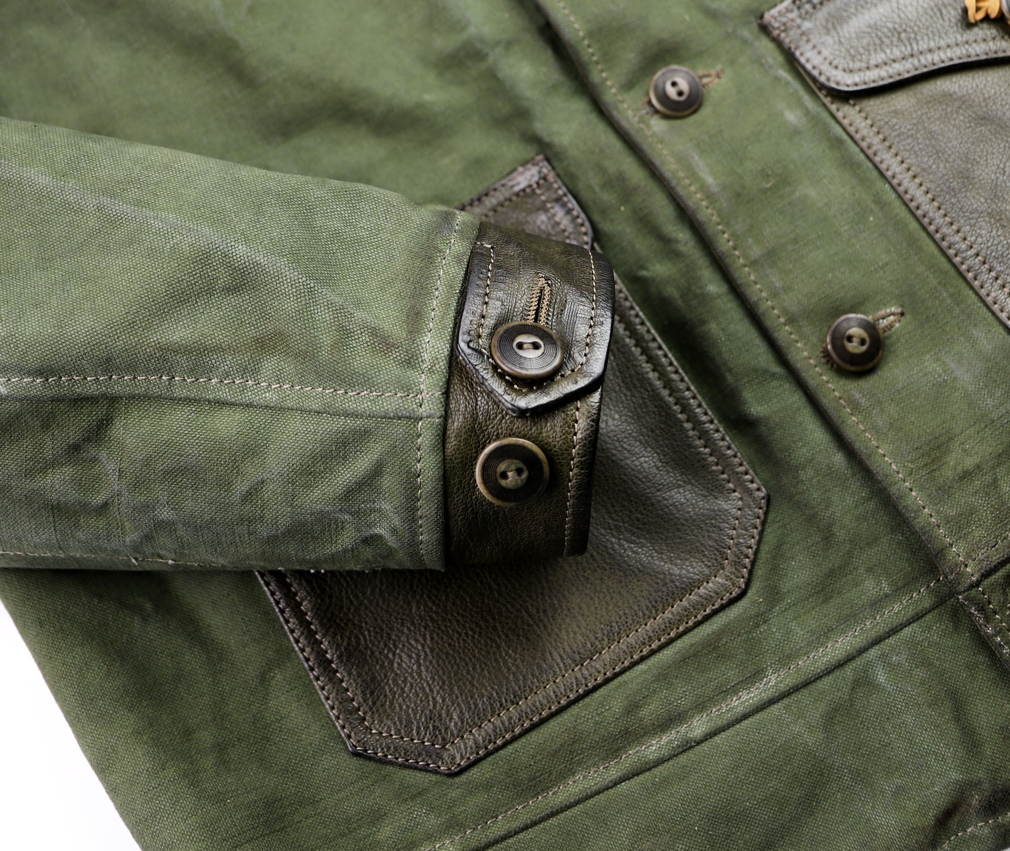 Thedi Canvas and Green Goatskin Button-Up button cuff.jpg