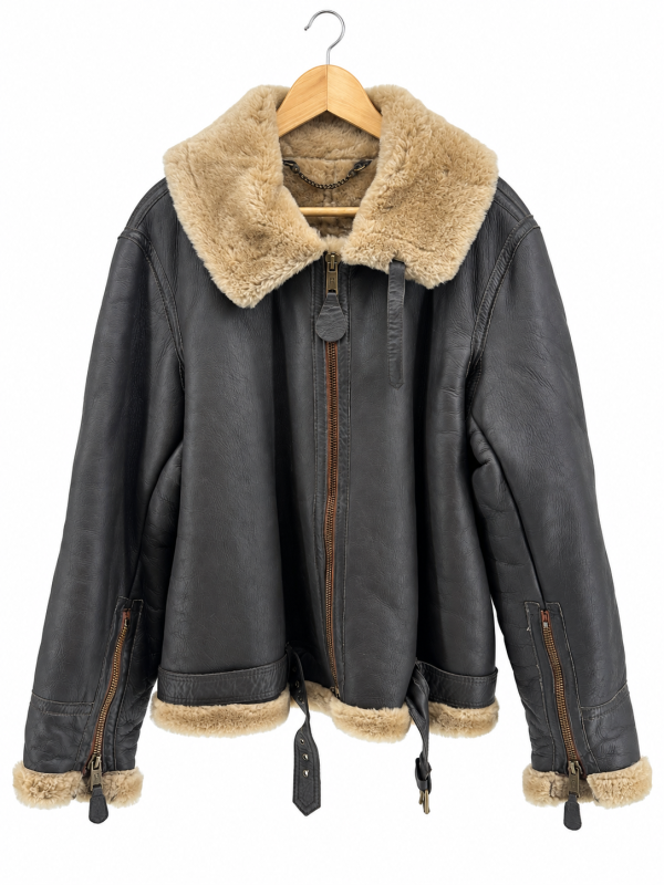 Charcoal shearling jacket on wooden hanger.png